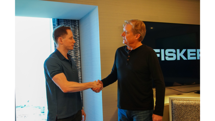Robert Ourisman, President and CEO of the Ourisman Automotive Group, with Fisker CEO Henrik Fisker after signing at NADA in Las Vegas.